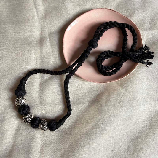  Braided black thread silver jewlery with carved beads.